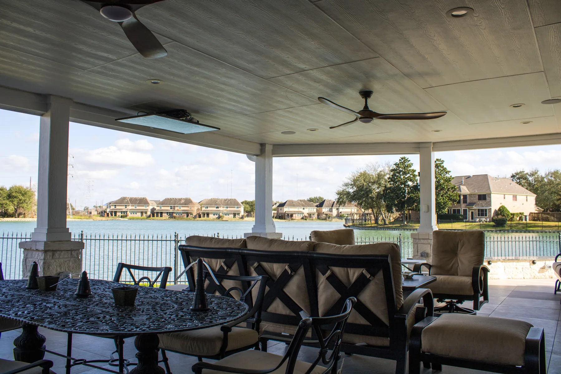 Paneled patio ceiling with integrated fans and recessed lights