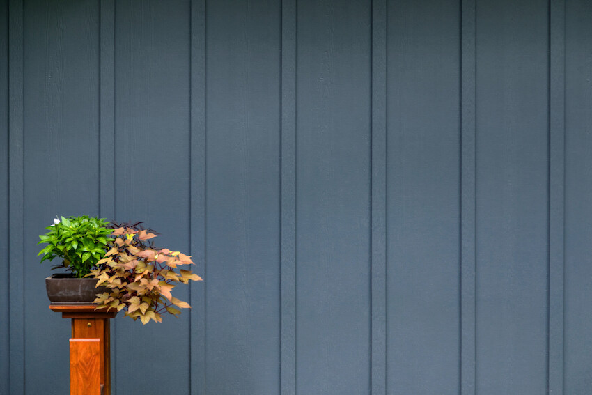 Close view of Evening Blue vertical James Hardie panel siding with battens