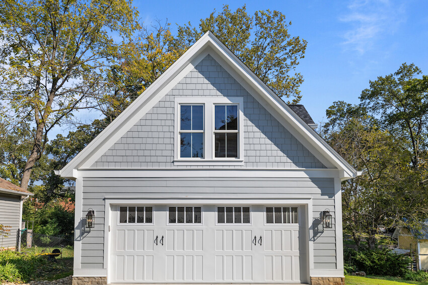 Gray exterior combining horizontal lap siding with shingle-style gable accents