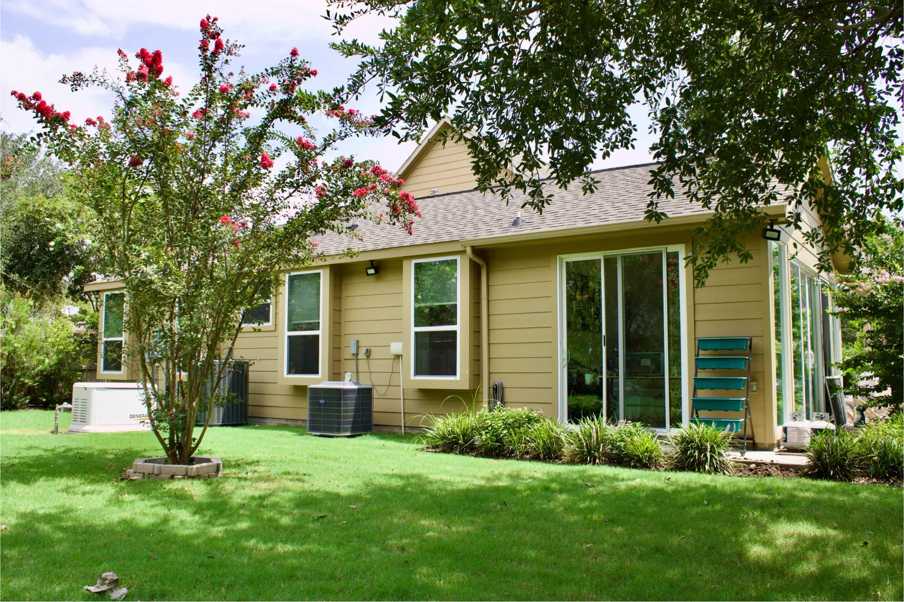 Finished tan horizontal siding on the rear exterior of a home