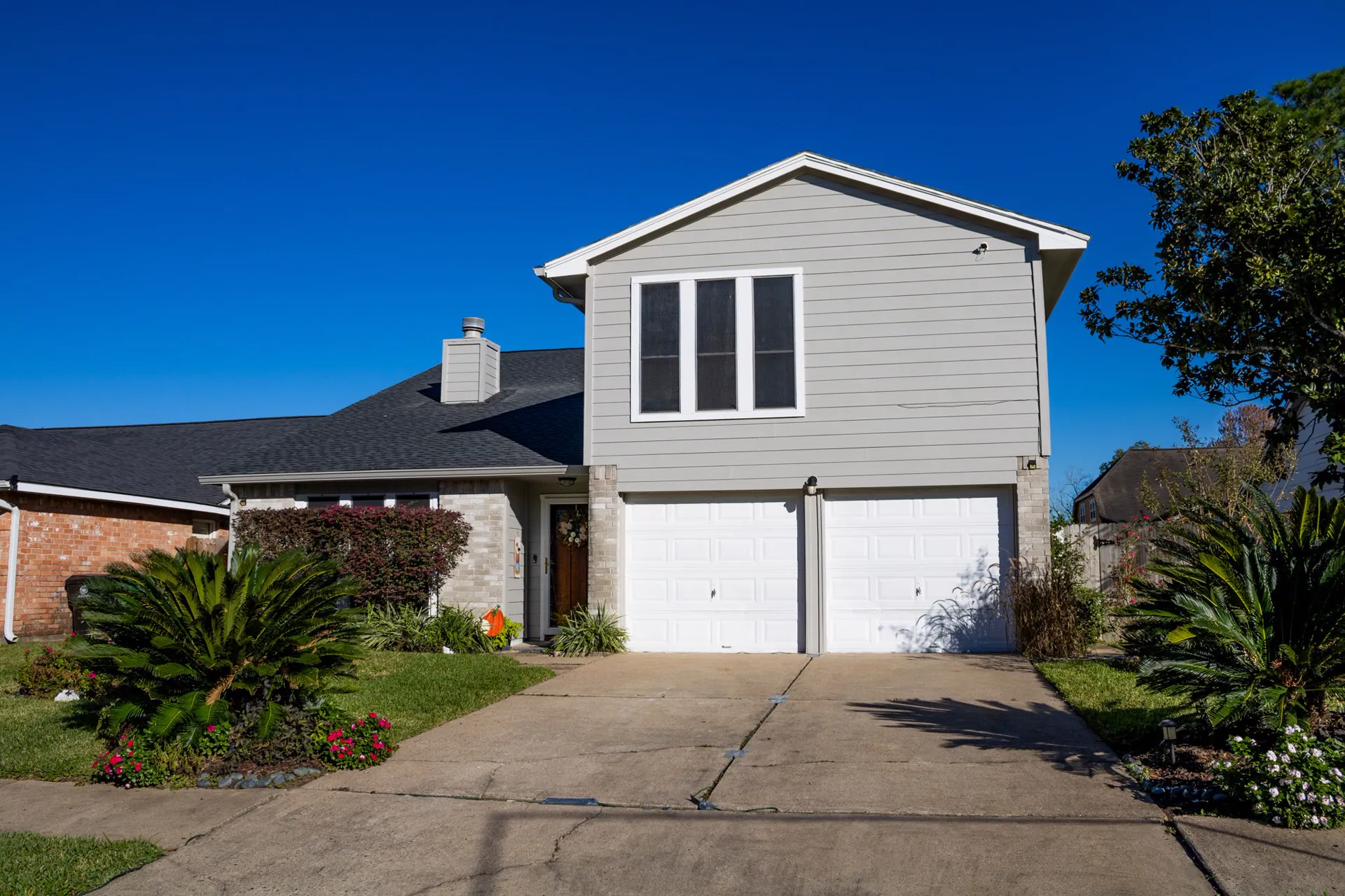 Completed gray siding replacement on a two-story home