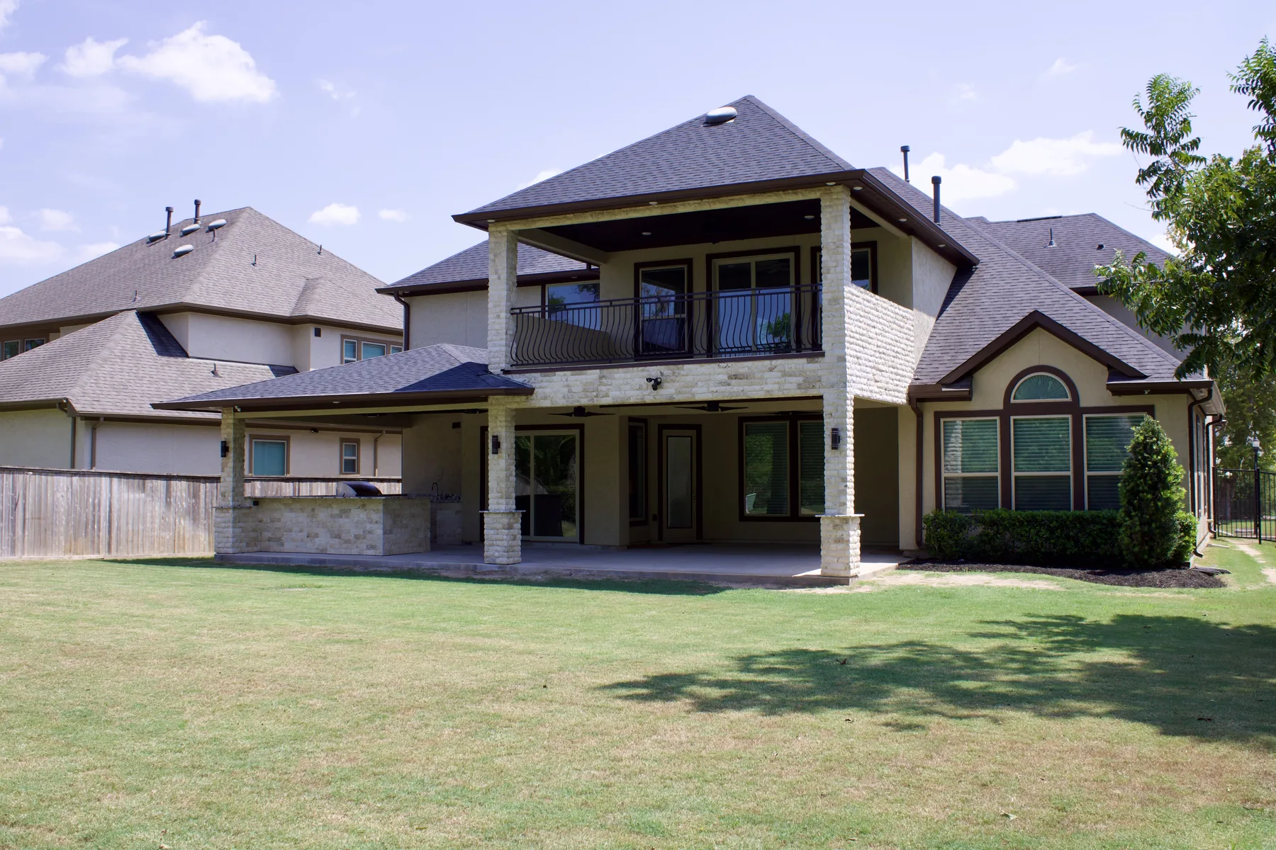 Two-story covered patio and outdoor kitchen built by Colony Builders in Katy