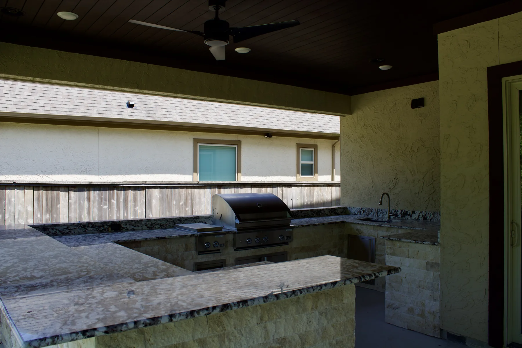 Stone-finished outdoor kitchen with broad countertop workspace