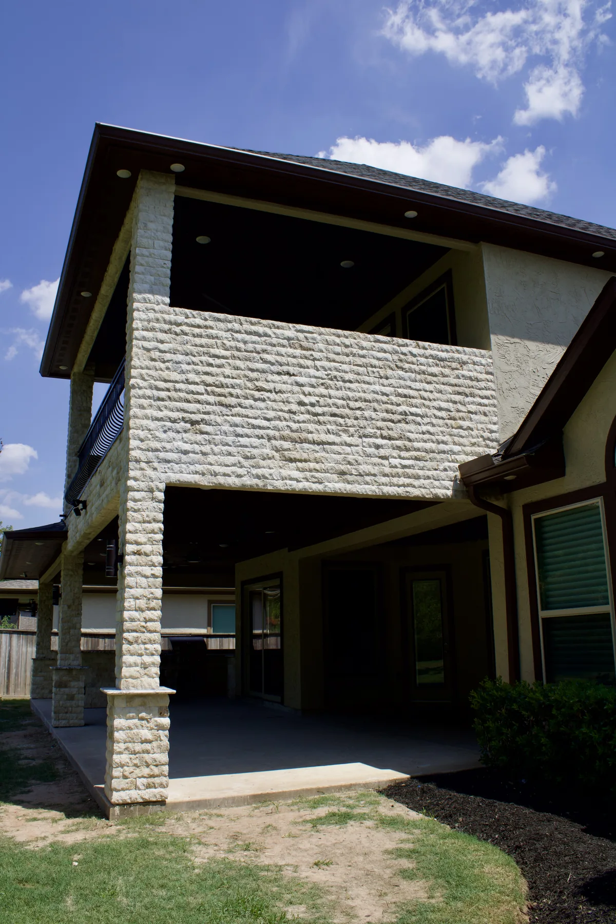 Recessed lighting in the stained-wood patio ceiling