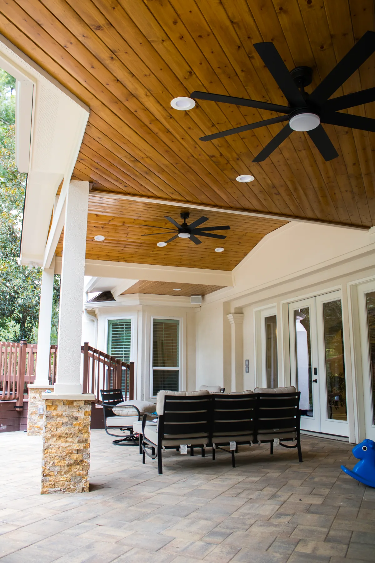 Tongue-and-groove wood ceiling and ceiling fan under the patio cover