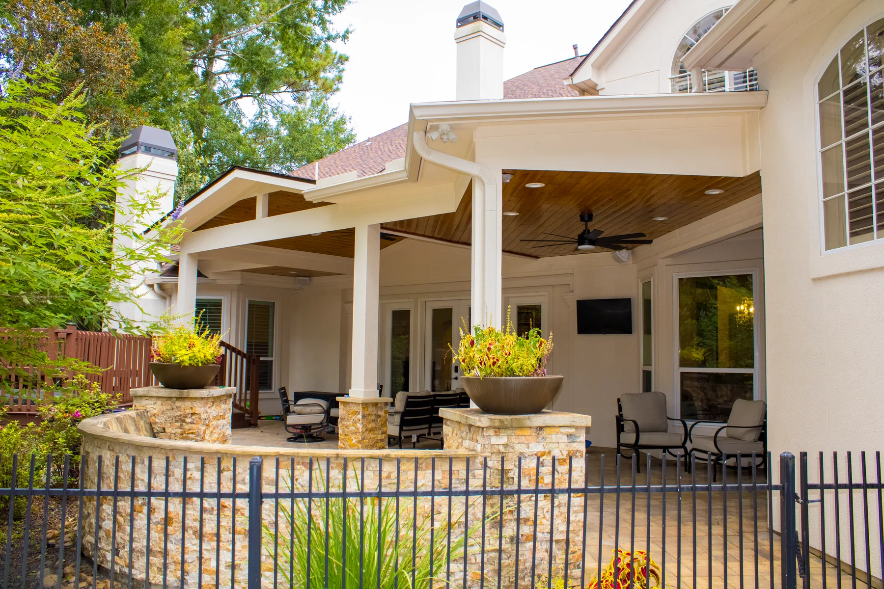 Stone-finished columns and covered outdoor-living area in River Oaks
