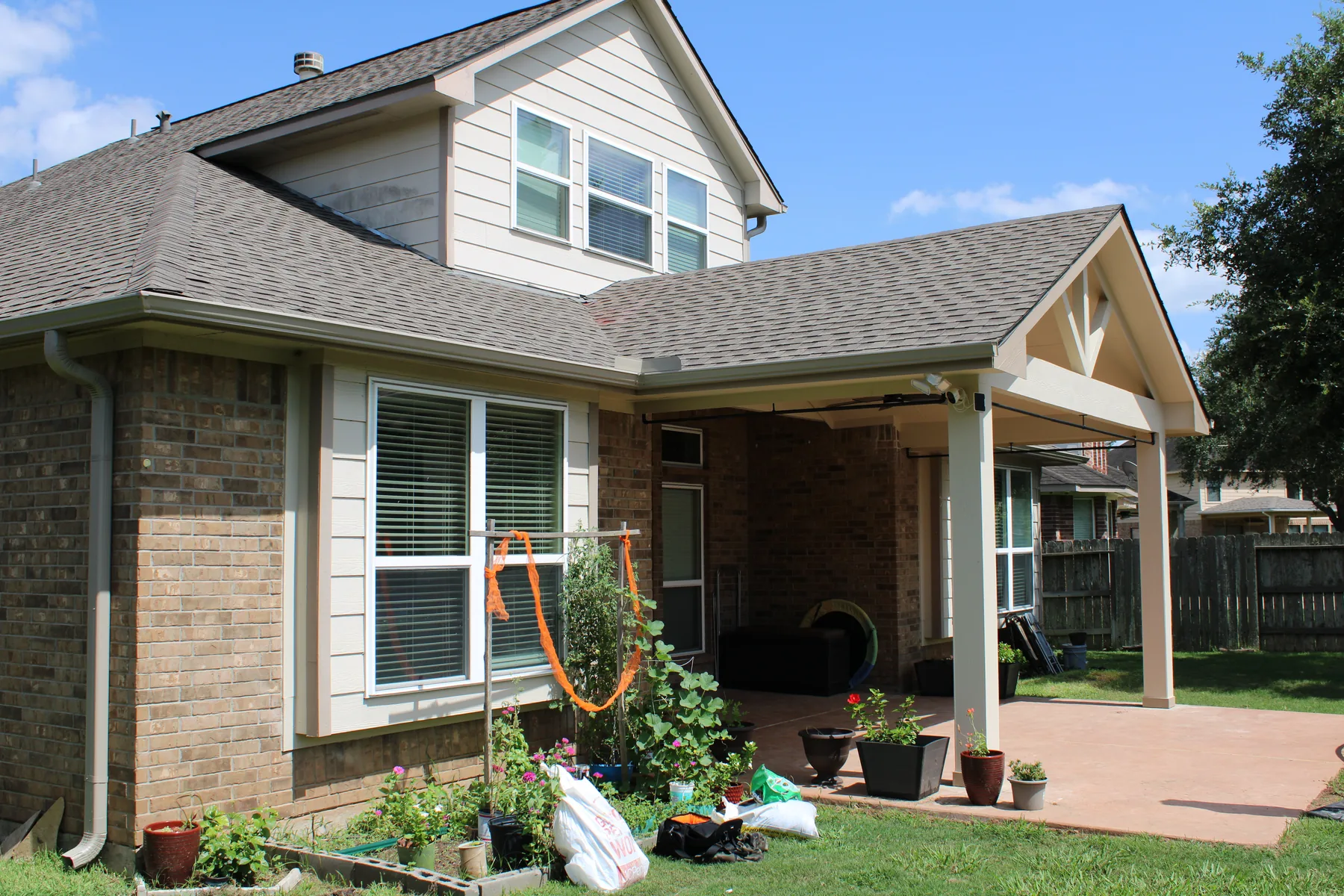 Open-gable detailing and coordinated shingles on the patio cover