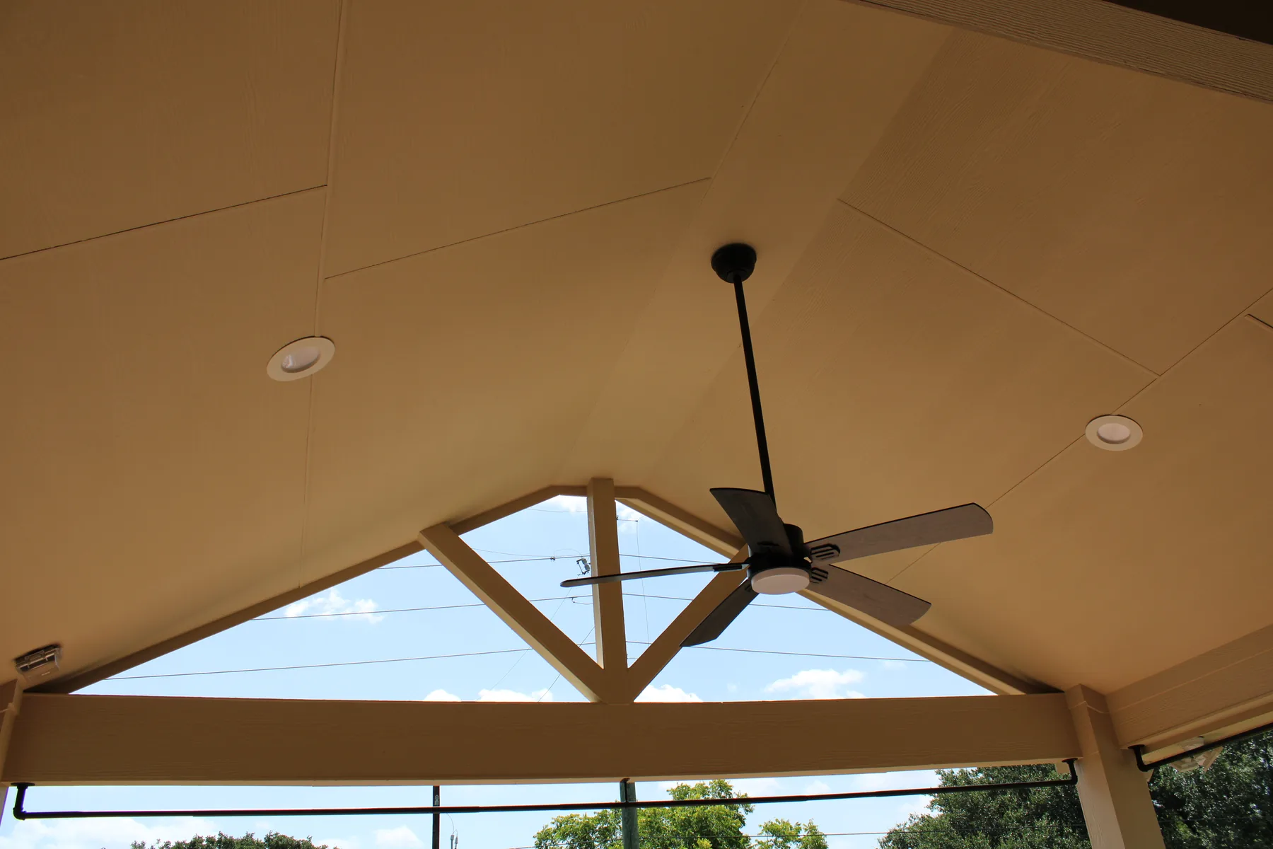 High paneled ceiling with fan and recessed lighting