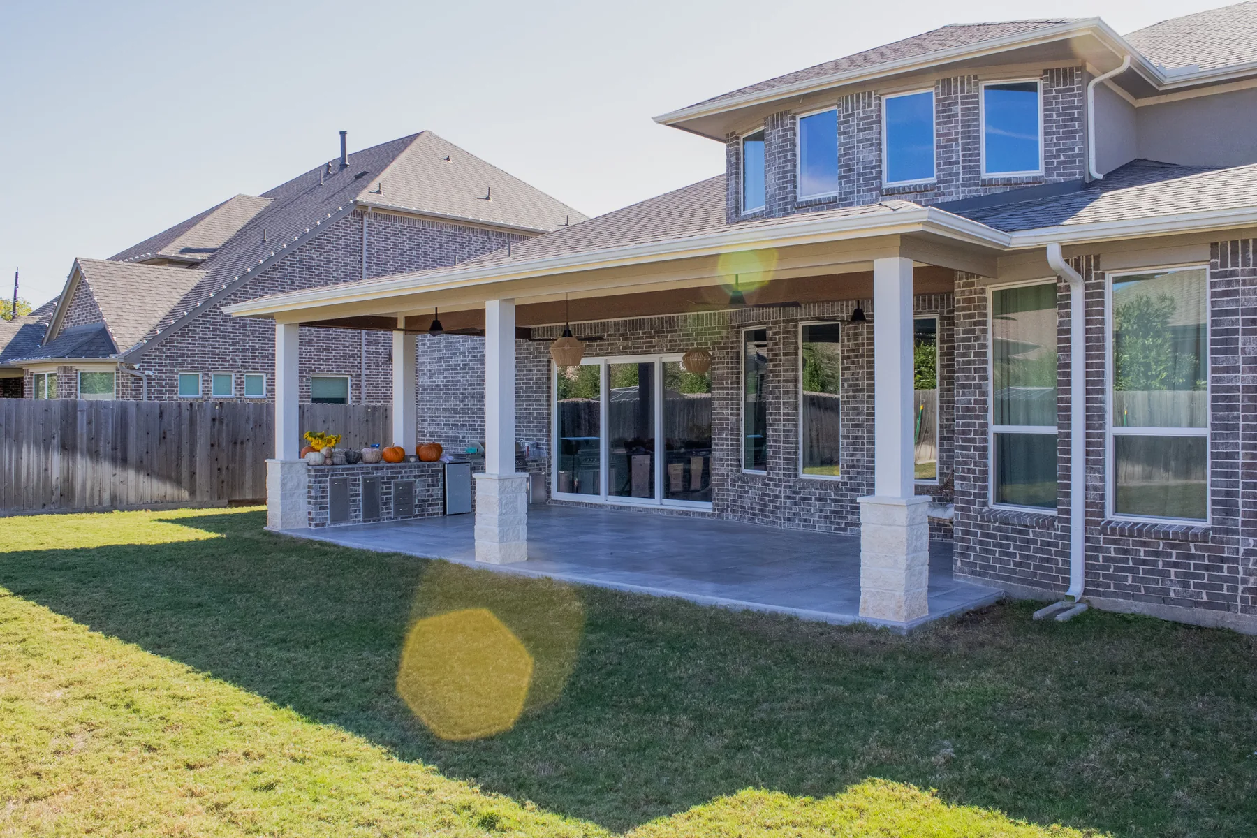 Patio cover and brick outdoor kitchen built by Colony Builders in The Woodlands