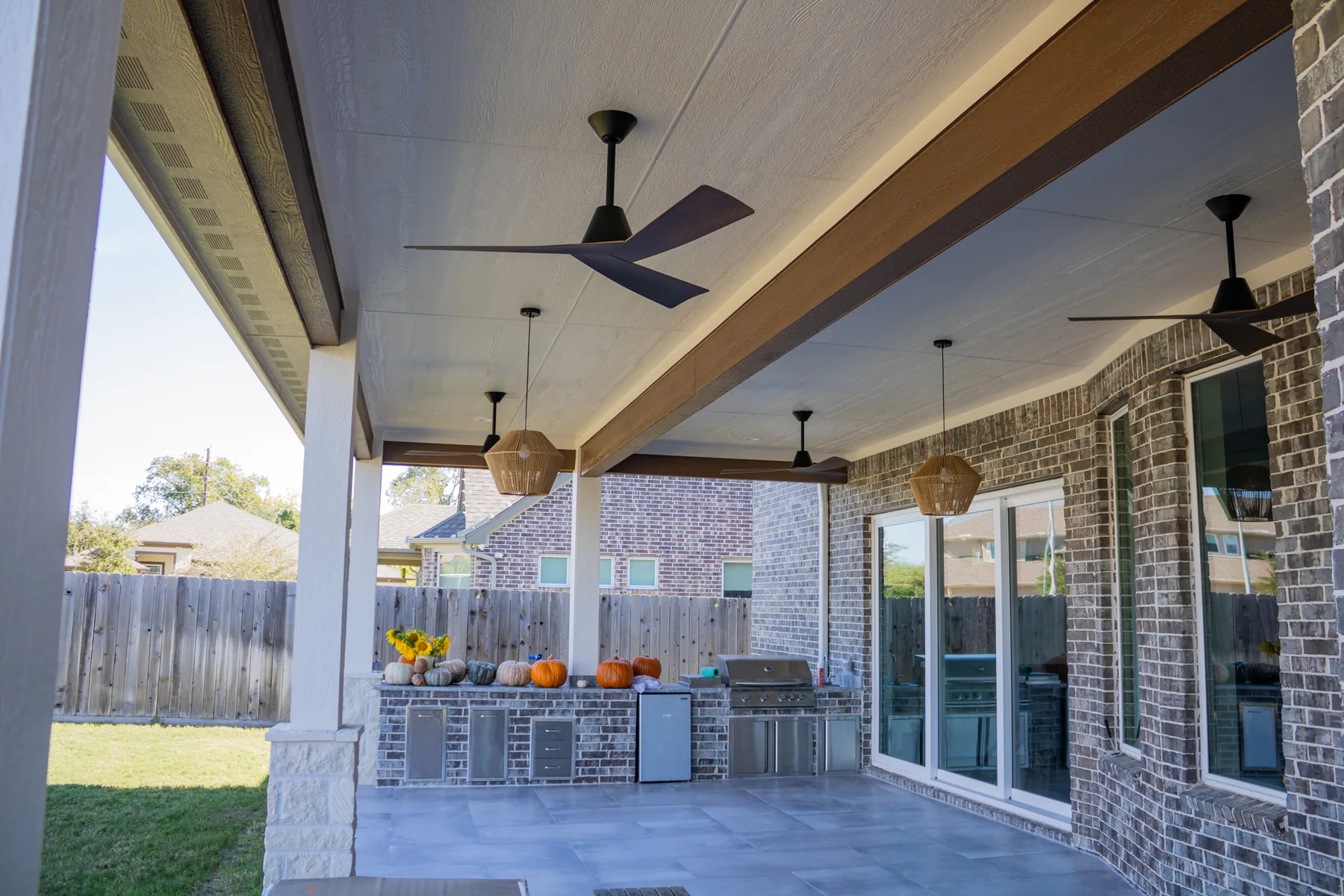 Stained accent beams and lighting beneath the patio cover